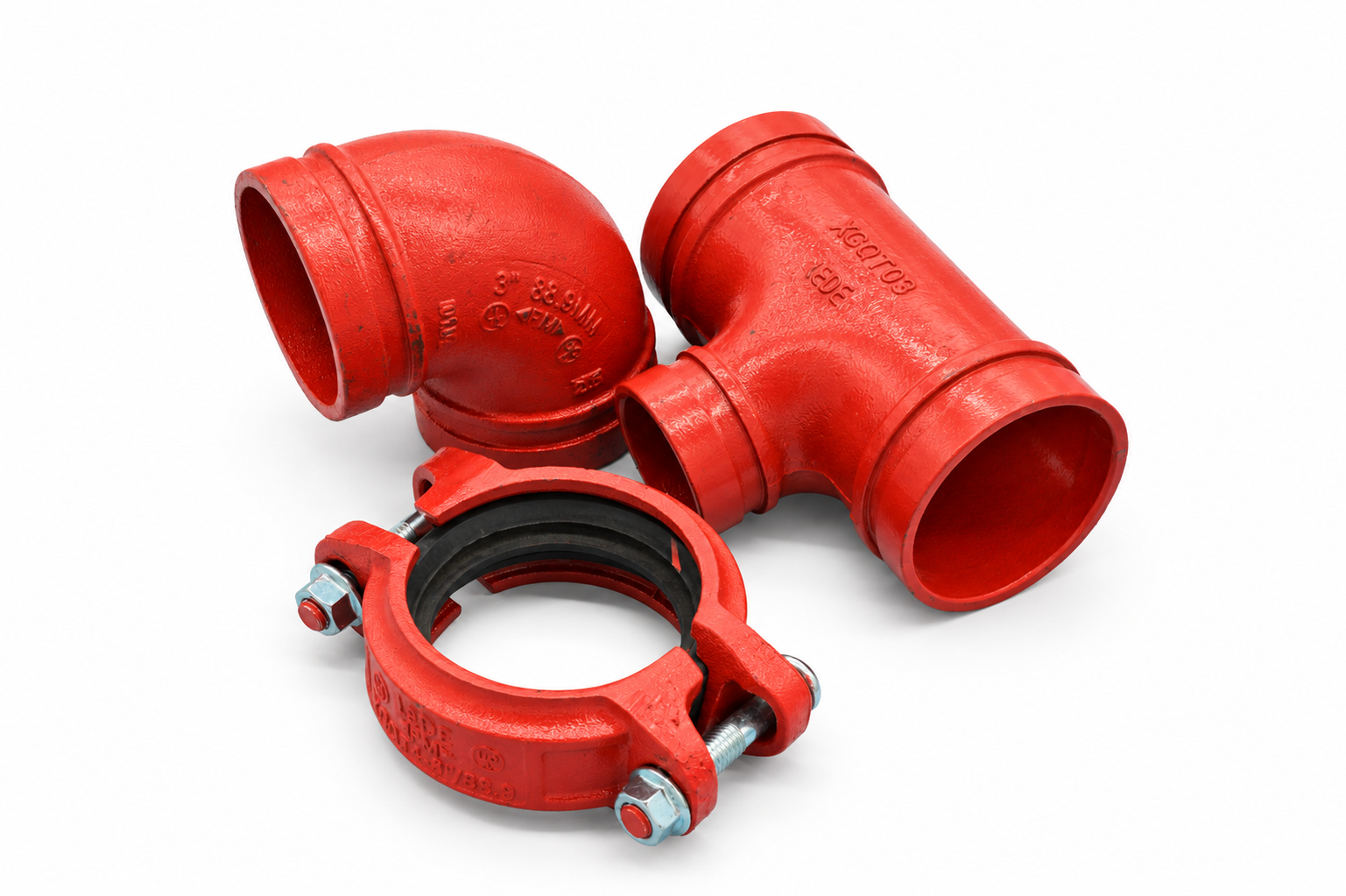Red two-bolt grooved coupling in front of a grooved elbow and tee